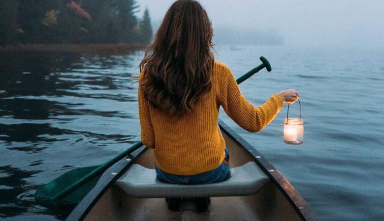 woman solo travelling in the middle of the lake in a boat