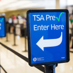 TSA PreCheck entrance sign at an airport security checkpoint, highlighting expedited screening options compared with Global Entry and CLEAR in 2026.