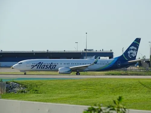 Alaska Airlines Atmos Rewards fleet at airport hub post-Hawaiian merger
