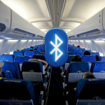 Bluetooth symbol displayed inside an airplane cabin showing wireless device use during flight.