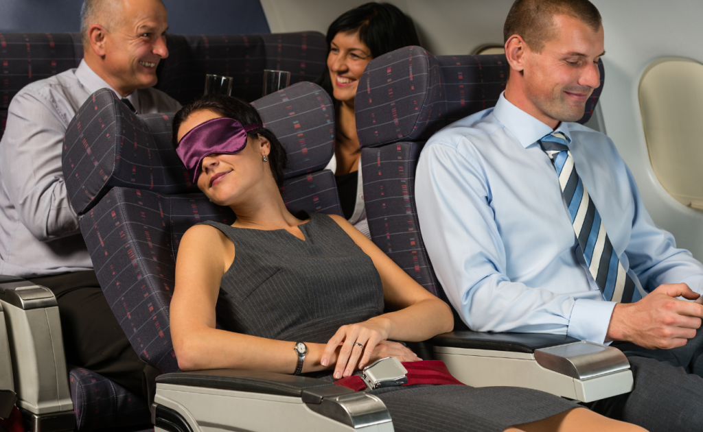Woman wearing eye mask sleeping on red-eye flights sleep on overnight flights.