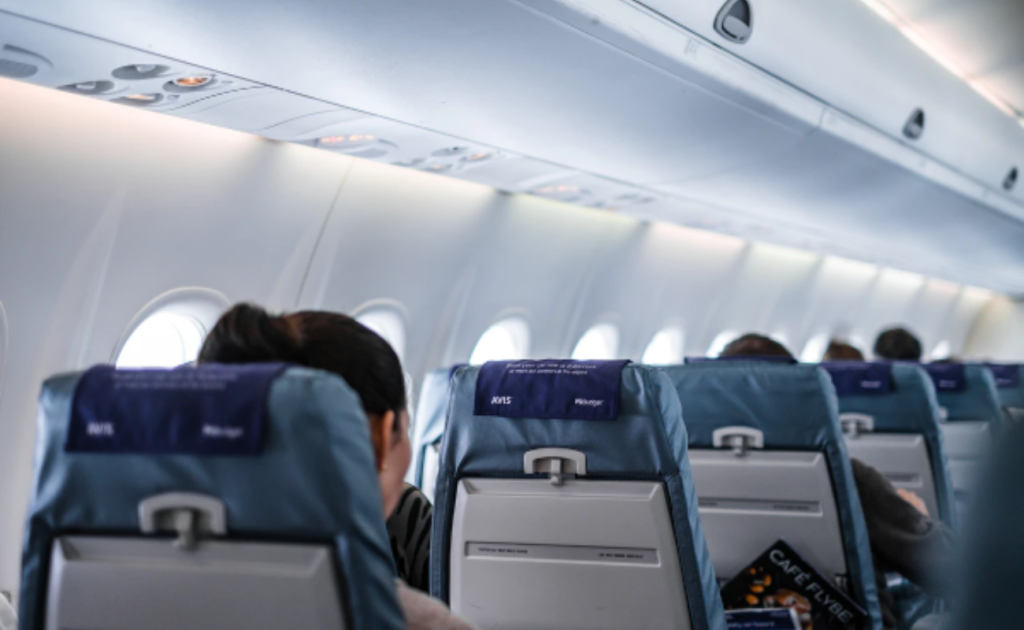 Airplane cabin view from a window seat on a UK to France flight