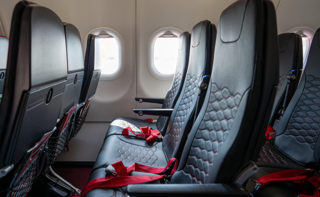 Business class airplane seats with lie-flat configuration and personal screens