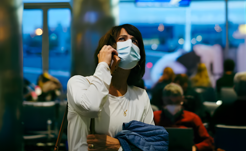 Traveler seated at airport checking in early to avoid losing seat under 2026 airline check-in rules.