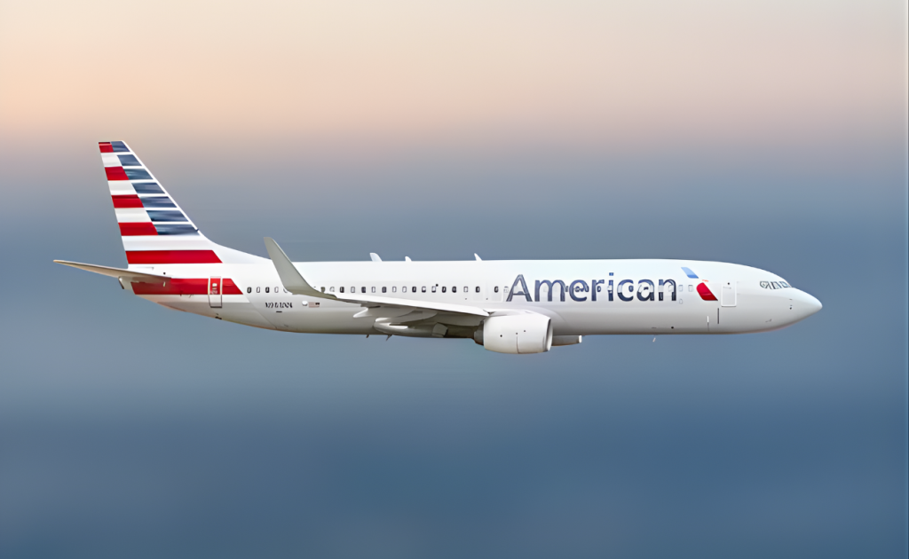 American Airlines aircraft in flight against a gradient sky, showcasing the striped tail and full livery.
