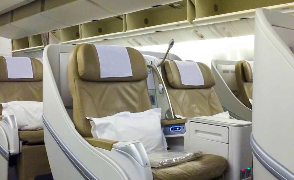 Premium business class pod seats with privacy shells and pillows