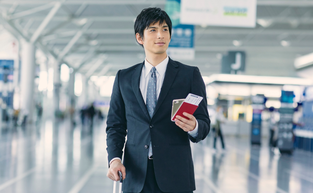 Business traveler holding passport and boarding pass after missing a boarding call in 2026.