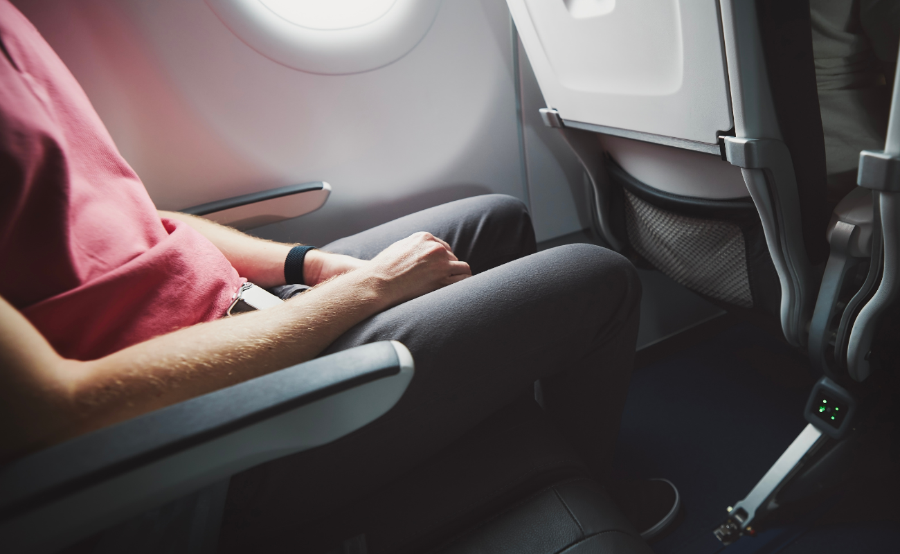 Premium airline seat with extra legroom, wide armrests, and privacy features in business class cabin