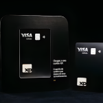 Sleek black XP Visa Infinite credit cards displayed dramatically, highlighting premium design and lounge benefits.