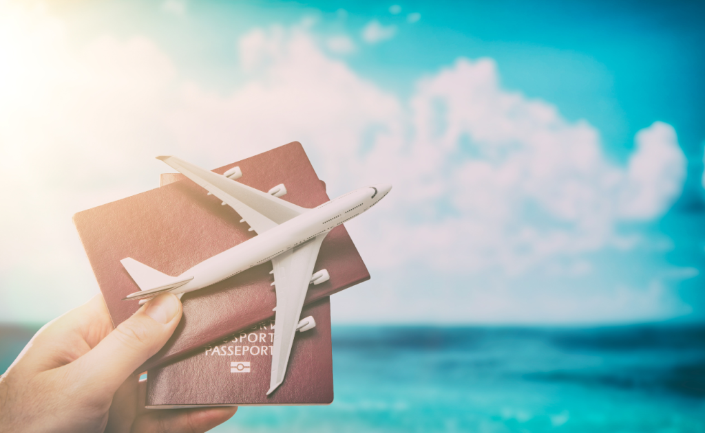 Passport and airplane symbolizing airline travel credits versus travel vouchers in 2026.