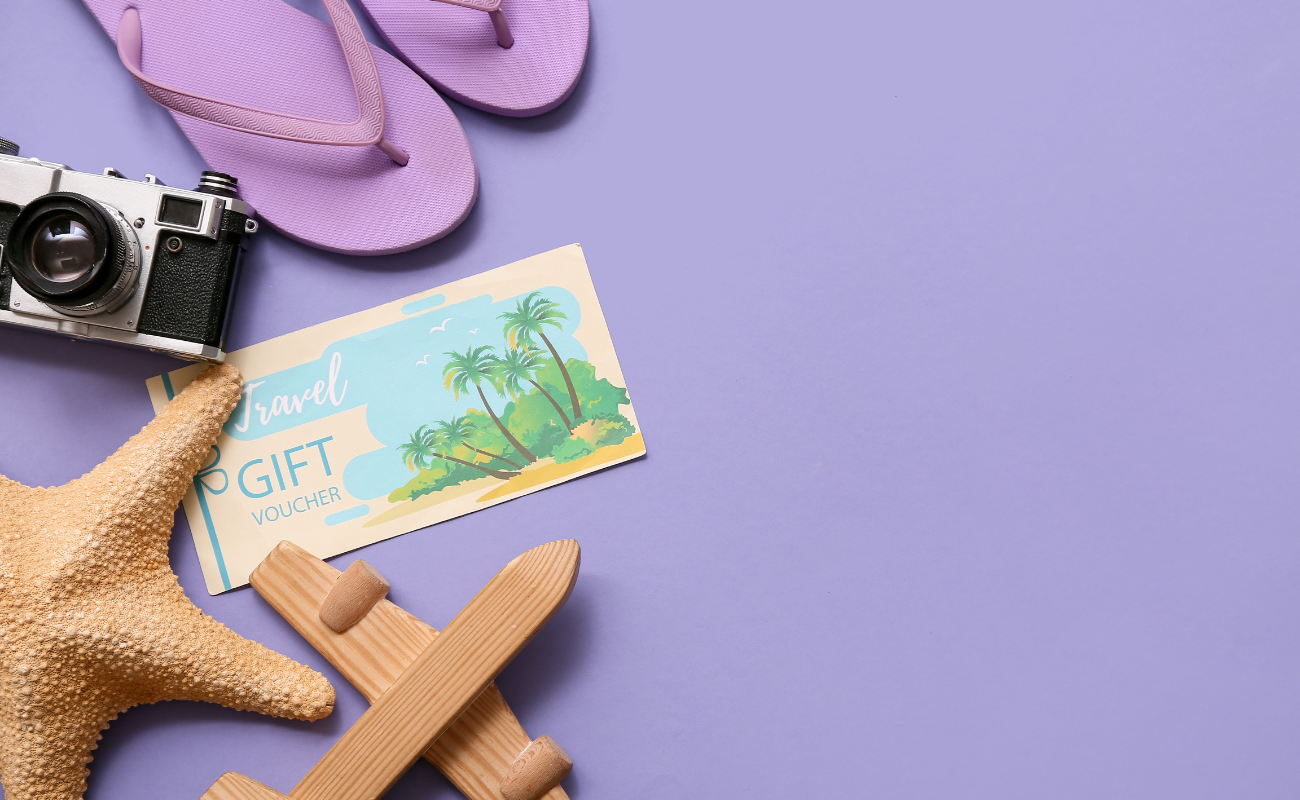 Travel voucher with travel accessories representing airline travel credits and vouchers in 2026.