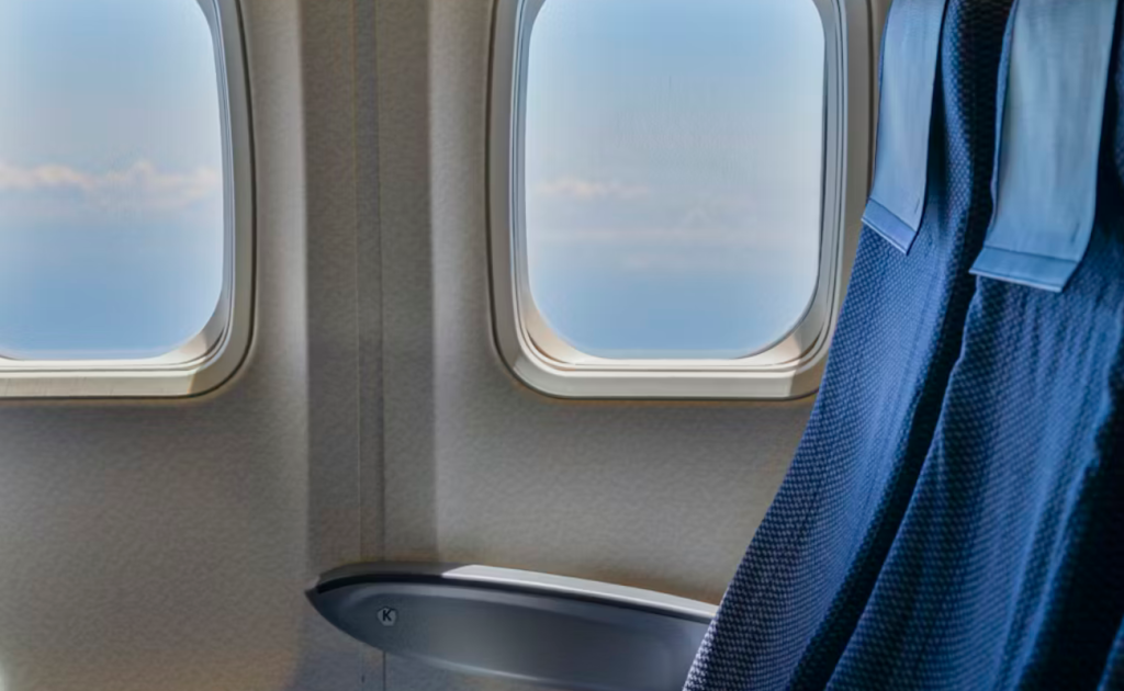Window seat with clouds visible during flight