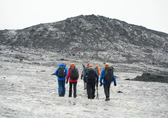 solo travelers enjoying the group travel in icy cold mountains.