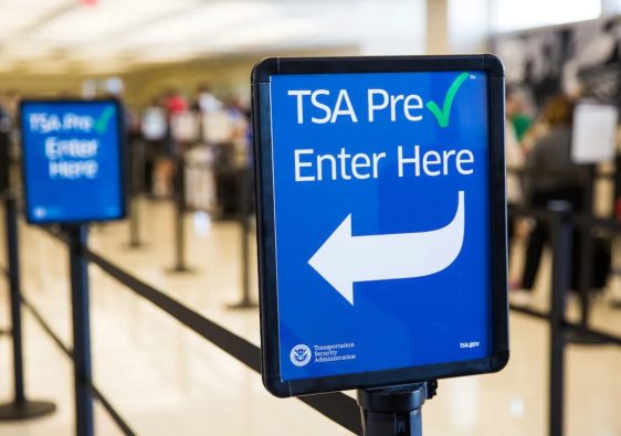 TSA PreCheck entrance sign at an airport security checkpoint, highlighting expedited screening options compared with Global Entry and CLEAR in 2026.