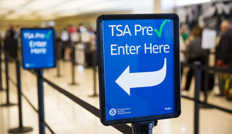 TSA PreCheck entrance sign at an airport security checkpoint, highlighting expedited screening options compared with Global Entry and CLEAR in 2026.